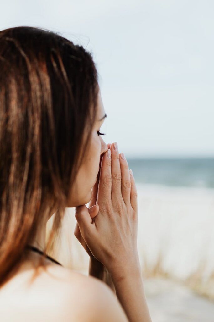 pexels photo 5202606 5202606 Woman meditating by the beach with hands together, embracing tranquility and peace.